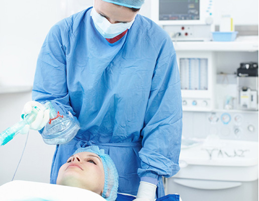 Doctor about to put patient under anaesthetic in operating room 